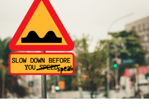 Road sign of speed breakers - slow down before you speed (and speak)